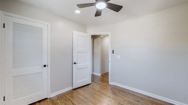 unfurnished bedroom featuring light wood-type flooring, a closet, and ceiling fan