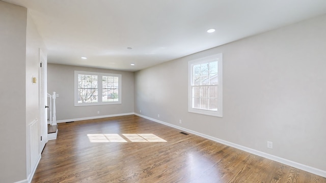 empty room with hardwood / wood-style flooring