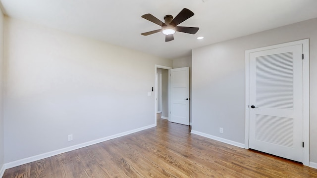 unfurnished bedroom with ceiling fan, light hardwood / wood-style floors, and a closet