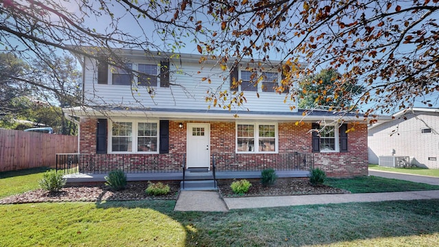 front facade with a front yard and central AC