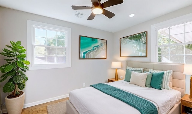 bedroom with hardwood / wood-style floors and ceiling fan