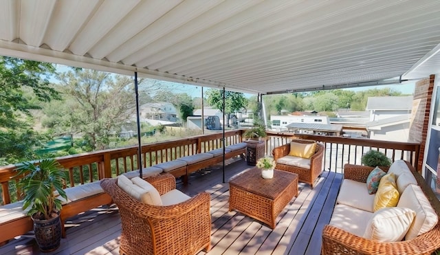 wooden terrace with an outdoor living space