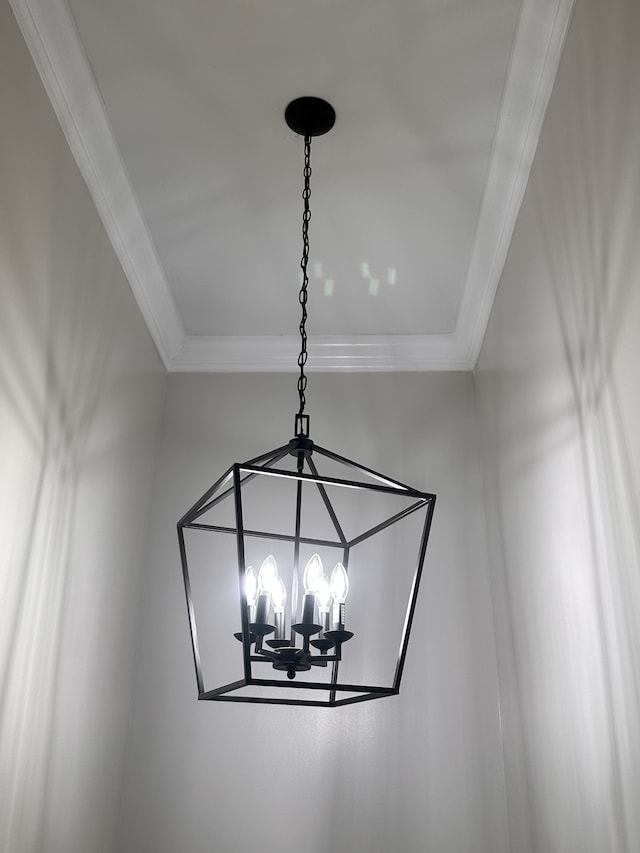 interior details with ornamental molding and a chandelier