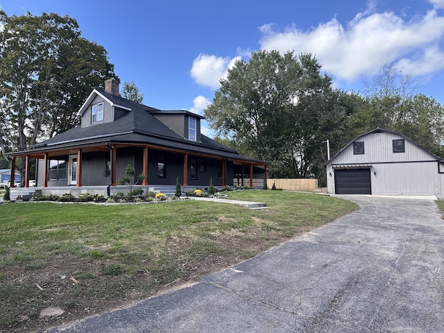 farmhouse inspired home with a front lawn, a porch, and a garage