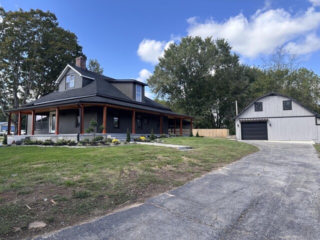 292 Quebeck Rd, Quebeck, TN 38579 - view of front of property featuring an outdoor structure, a detached garage, a porch, and a front lawn