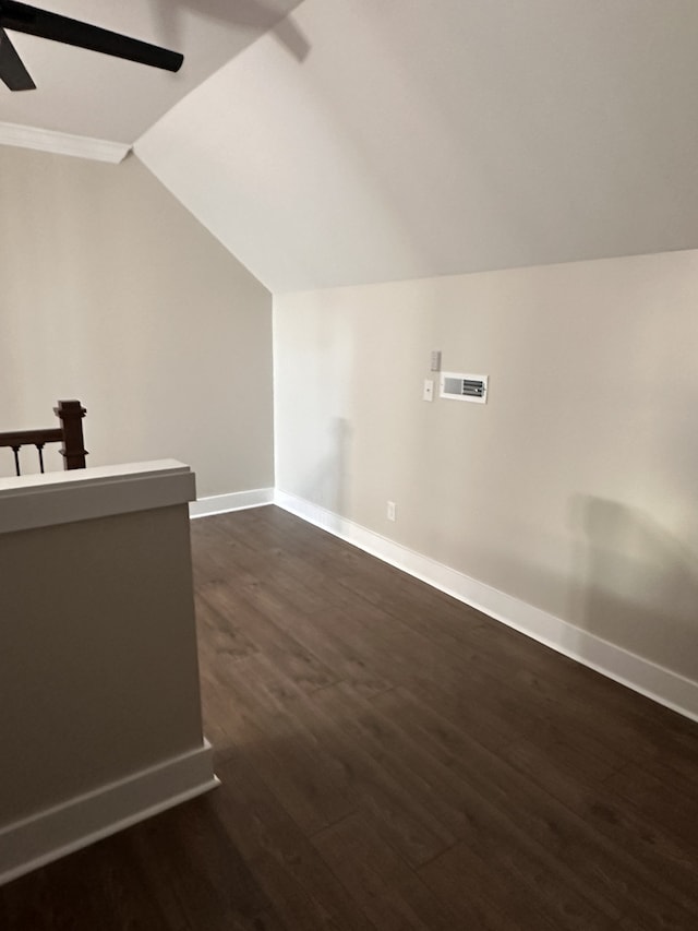 additional living space with dark wood-type flooring, vaulted ceiling, and ceiling fan