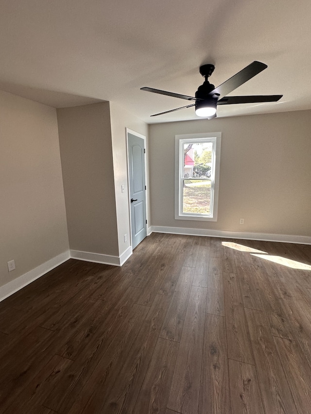 spare room with ceiling fan and dark hardwood / wood-style floors