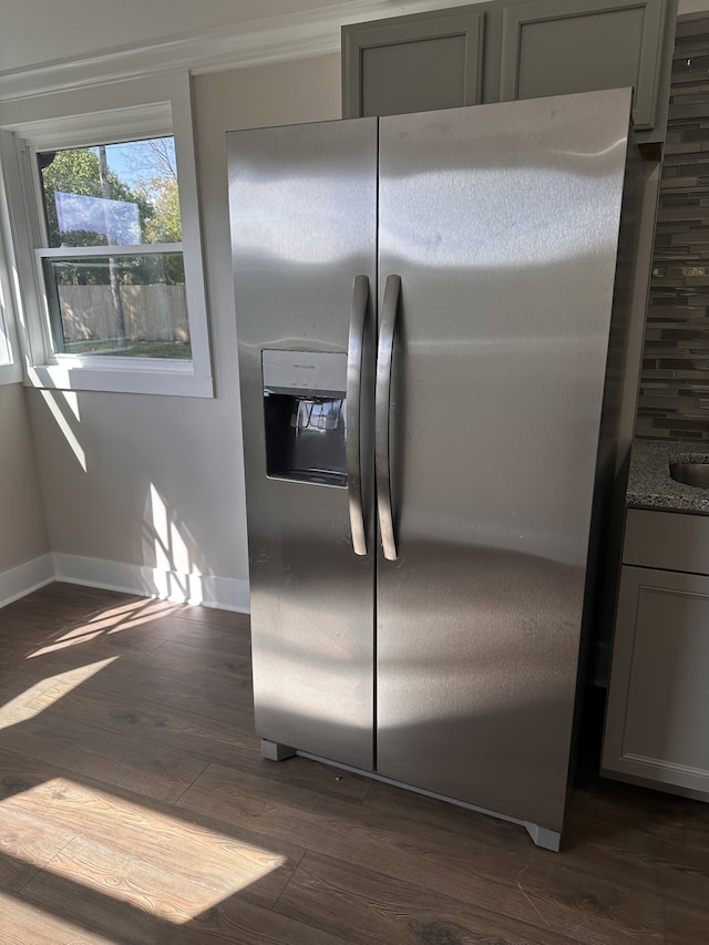 kitchen with stainless steel refrigerator with ice dispenser, dark hardwood / wood-style flooring, and gray cabinetry