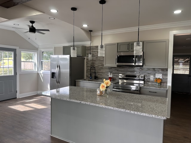 kitchen with tasteful backsplash, gray cabinetry, dark hardwood / wood-style flooring, vaulted ceiling, and appliances with stainless steel finishes