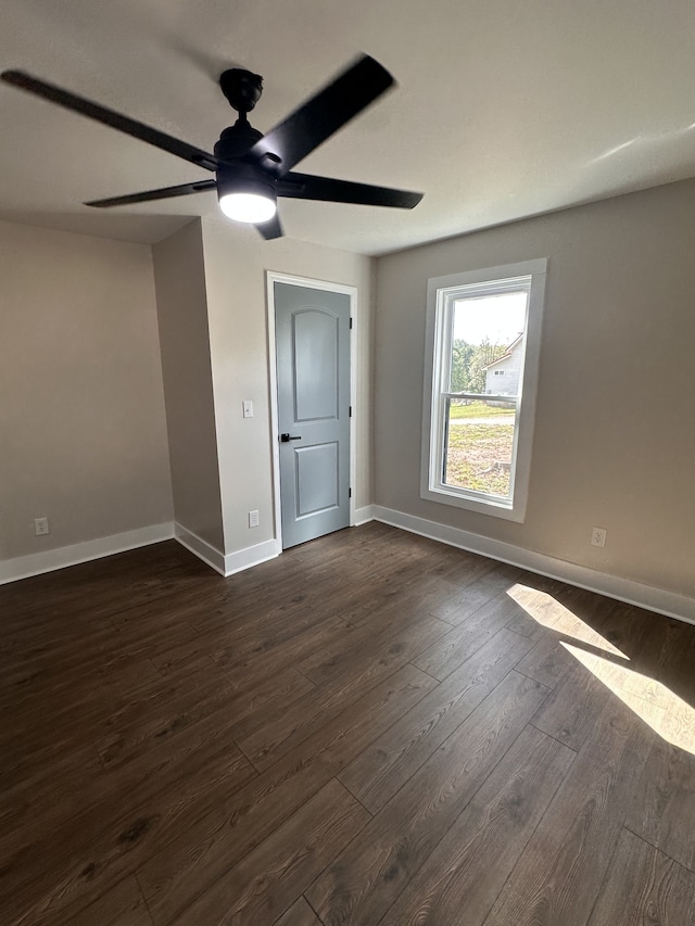 spare room featuring ceiling fan and dark hardwood / wood-style flooring