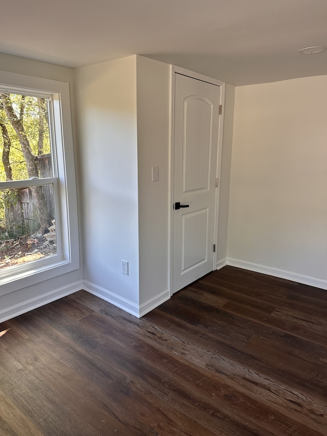 spare room featuring dark hardwood / wood-style flooring