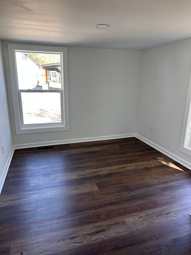 unfurnished room featuring dark wood-type flooring