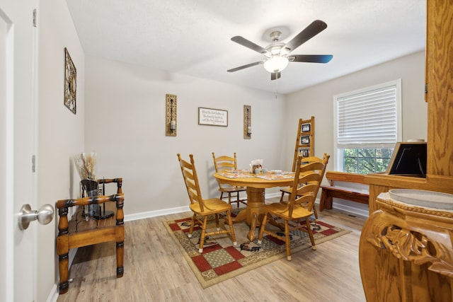 dining room with light wood-type flooring and ceiling fan