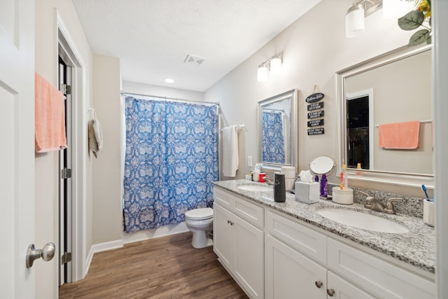 bathroom with vanity, hardwood / wood-style floors, toilet, and a shower with shower curtain