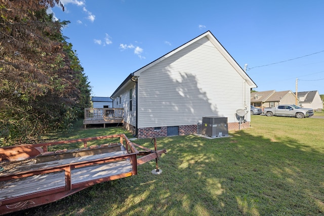 view of home's exterior featuring a wooden deck, central AC unit, and a yard