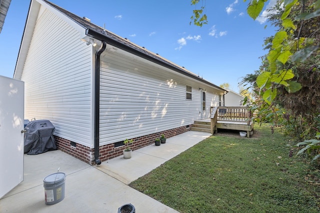 view of home's exterior featuring a patio, a yard, and a deck