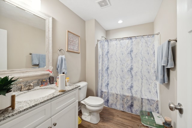 bathroom featuring wood-type flooring, vanity, toilet, and a shower with shower curtain