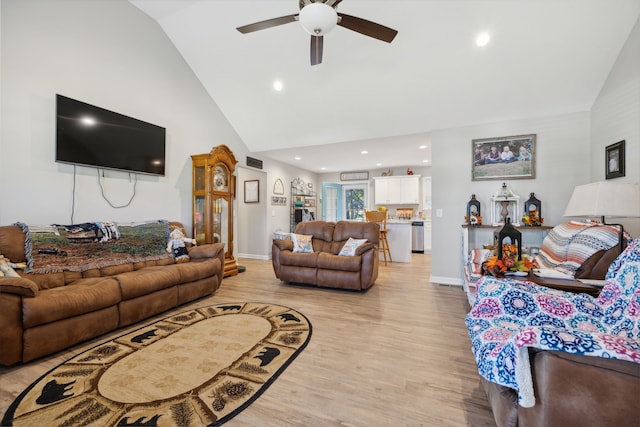 living room featuring high vaulted ceiling, light hardwood / wood-style floors, and ceiling fan