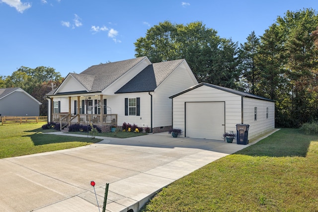 view of front of house featuring an outdoor structure, a garage, covered porch, and a front yard