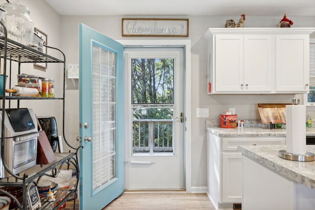 doorway to outside with light wood-type flooring