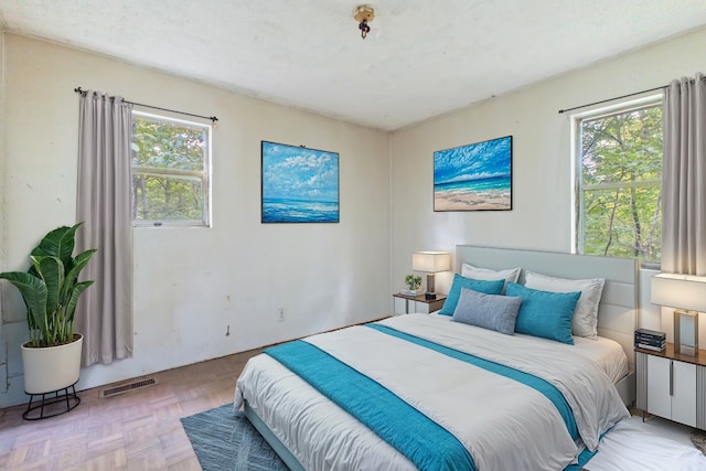 bedroom featuring light parquet floors