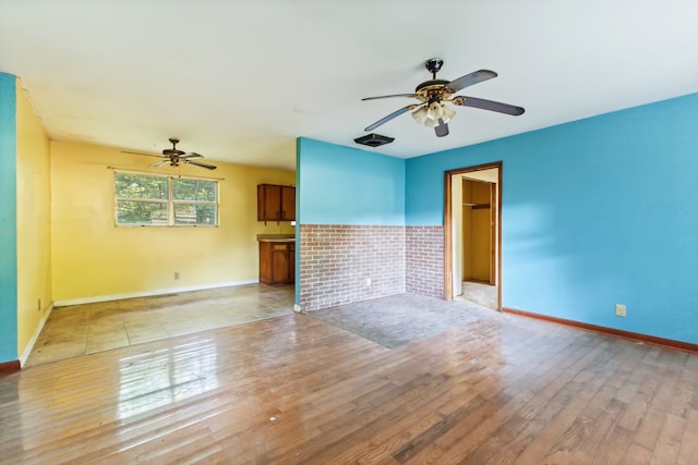 unfurnished living room with light wood-type flooring and ceiling fan