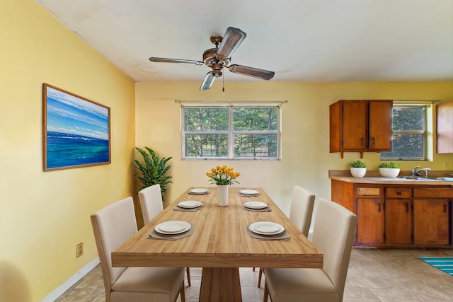 dining area featuring sink, ceiling fan, and plenty of natural light