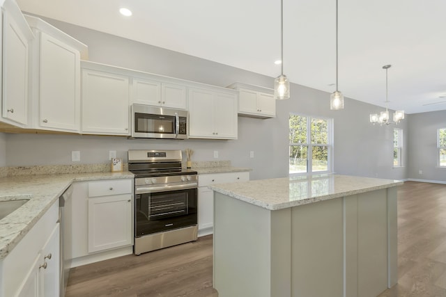 kitchen featuring white cabinets, appliances with stainless steel finishes, and plenty of natural light