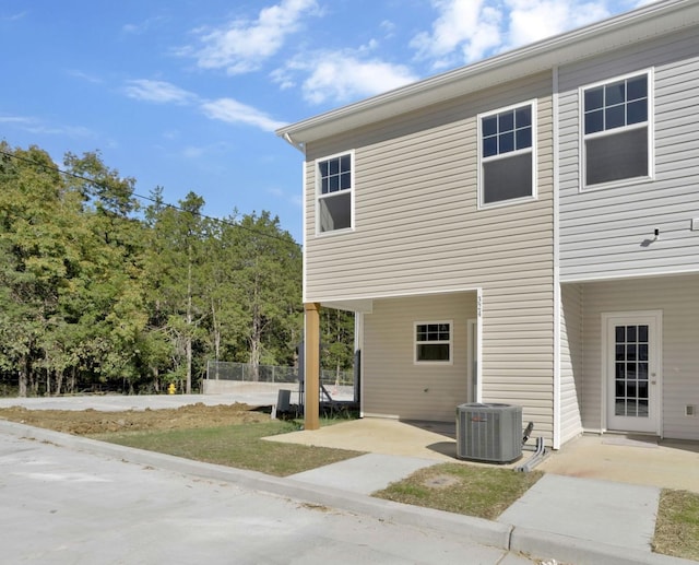 back of house featuring central air condition unit