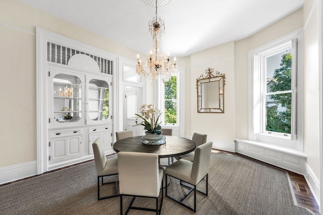 dining room featuring plenty of natural light, a chandelier, and dark hardwood / wood-style flooring