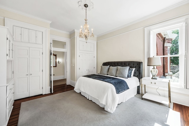 bedroom with ornamental molding, a chandelier, and dark hardwood / wood-style flooring