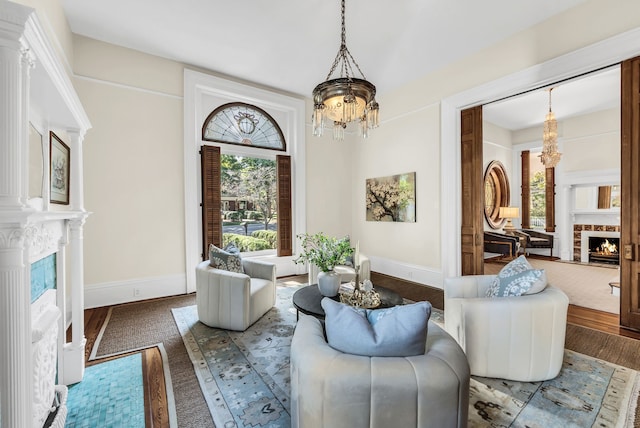 living area featuring hardwood / wood-style flooring and a notable chandelier