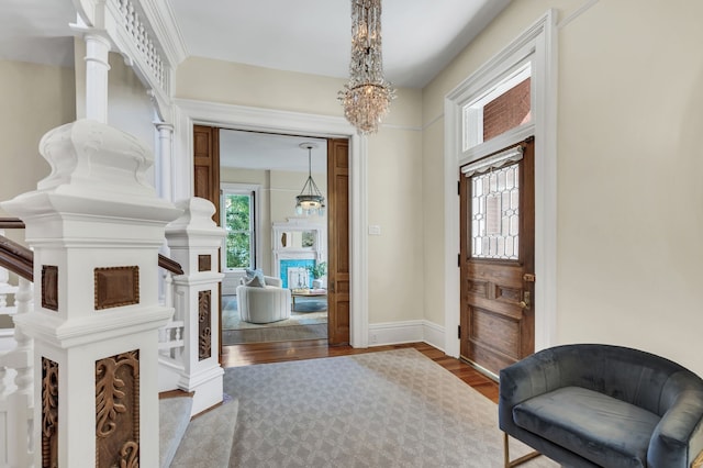 entrance foyer featuring hardwood / wood-style floors and an inviting chandelier