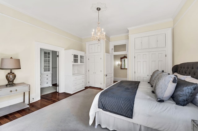 bedroom featuring a closet, ornamental molding, a chandelier, and dark hardwood / wood-style flooring