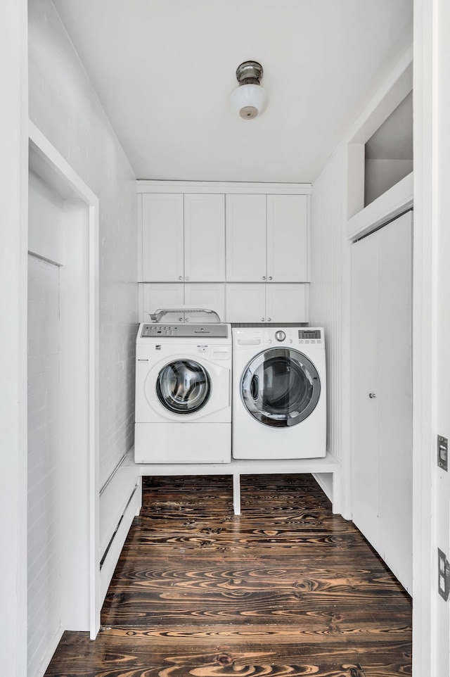 laundry area featuring washer and clothes dryer and dark hardwood / wood-style floors