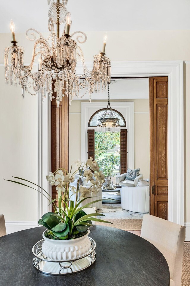 carpeted dining room featuring an inviting chandelier