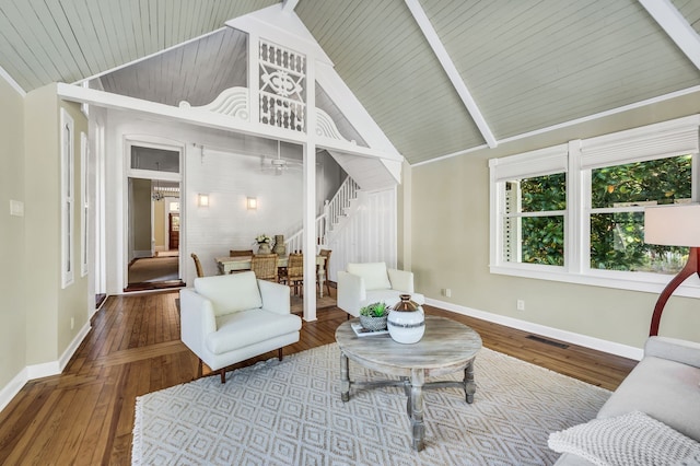 living room featuring vaulted ceiling with beams, hardwood / wood-style flooring, and wood ceiling