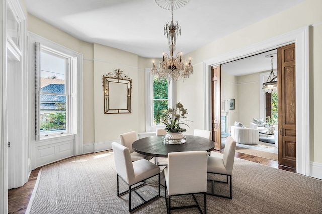 dining room featuring a notable chandelier and dark hardwood / wood-style flooring