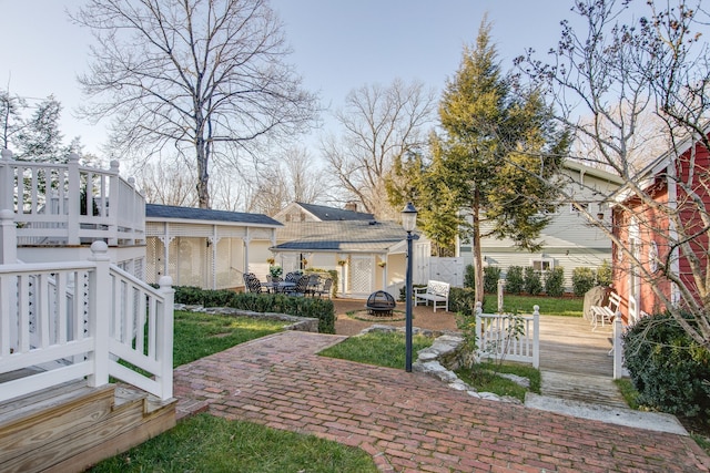 surrounding community with a patio area and a wooden deck