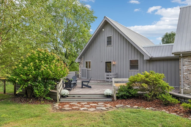 back of house featuring a deck and a yard