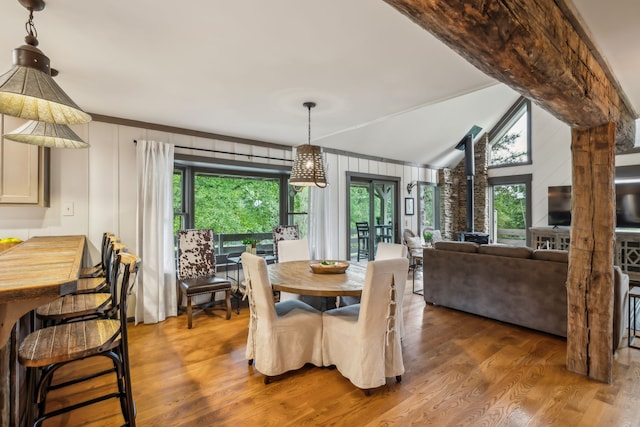 dining room featuring vaulted ceiling and hardwood / wood-style floors