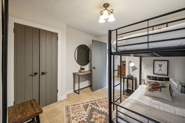 tiled bedroom with a textured ceiling