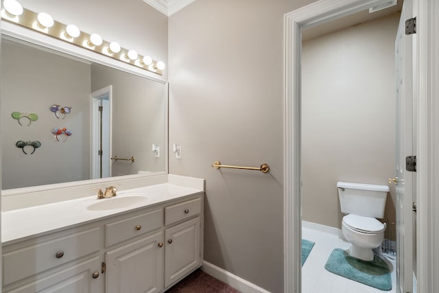 bathroom with tile patterned flooring, vanity, toilet, and ornamental molding