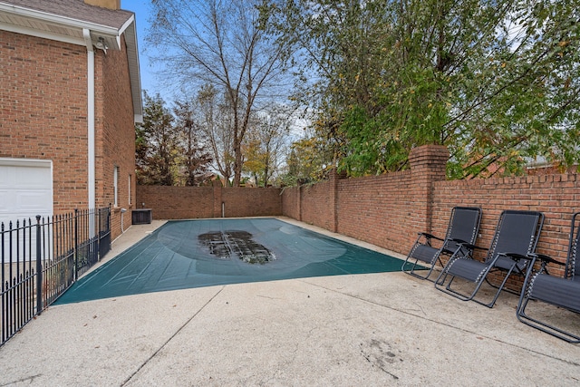 view of swimming pool with a patio and cooling unit