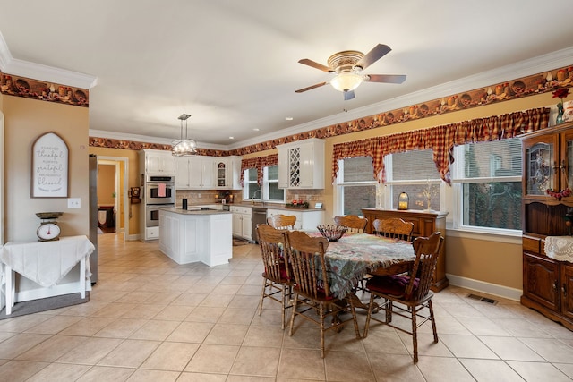 dining room featuring light tile patterned flooring, ceiling fan, and ornamental molding