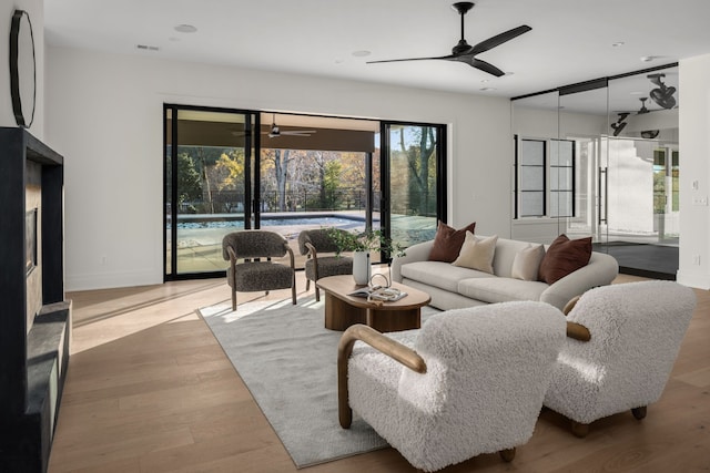 living room with hardwood / wood-style floors and ceiling fan