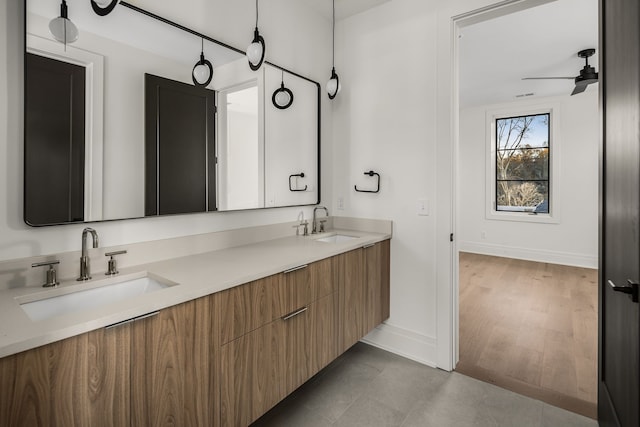 bathroom with vanity, hardwood / wood-style flooring, and ceiling fan