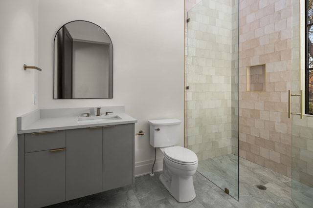 bathroom with vanity, toilet, and a shower with door