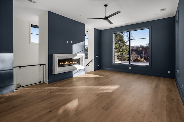 unfurnished living room with light wood-type flooring and ceiling fan