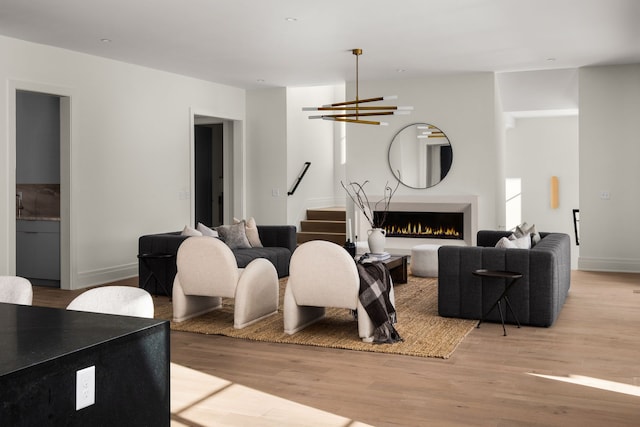 living room featuring light hardwood / wood-style floors and a chandelier